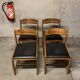 Set of four vintage chairs upholstered in retro design faux leather.