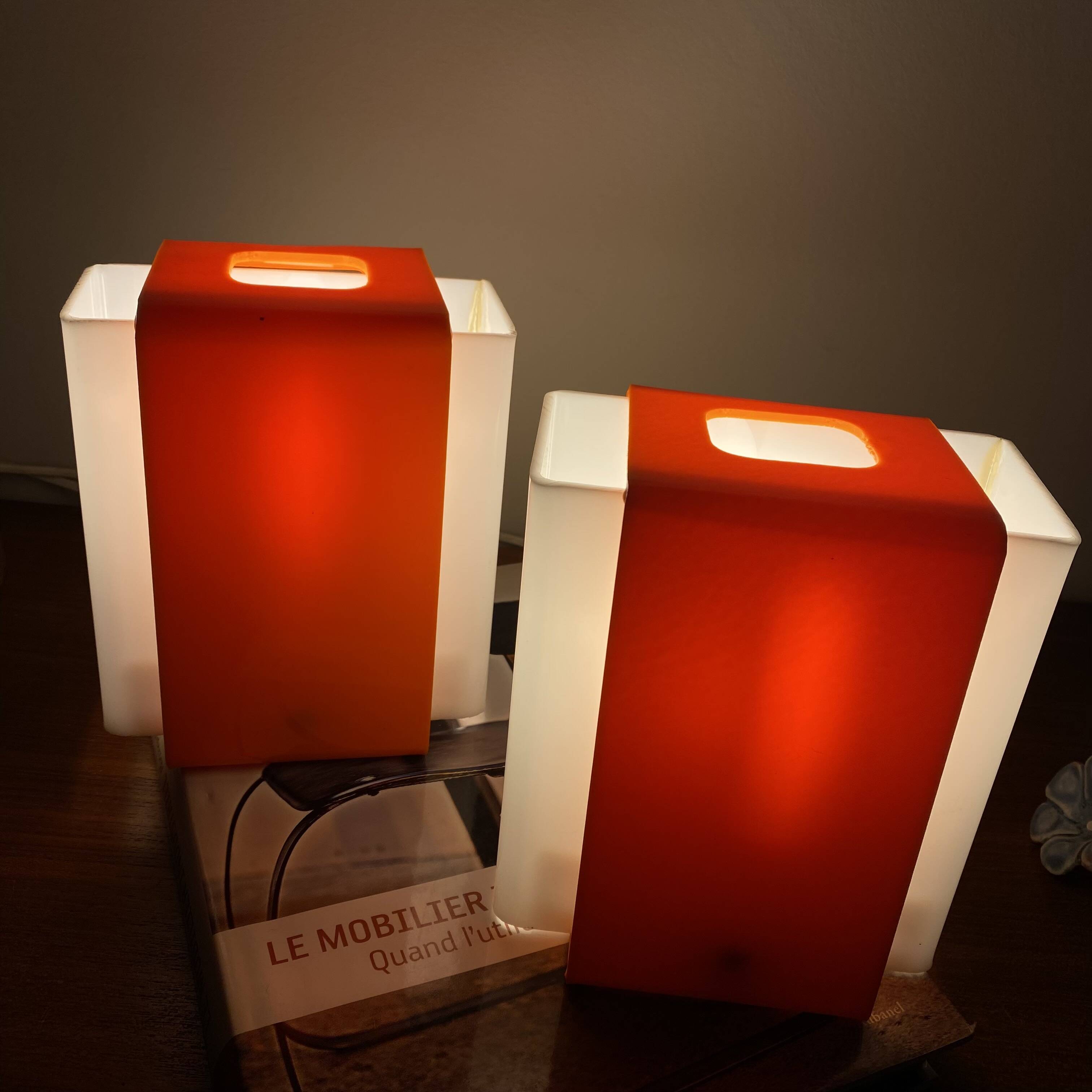 Pair of orange plexiglass wall sconces from the seventies.