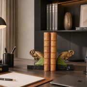 Art Deco pair of bookends with ram's heads, patinated metal and black marble.