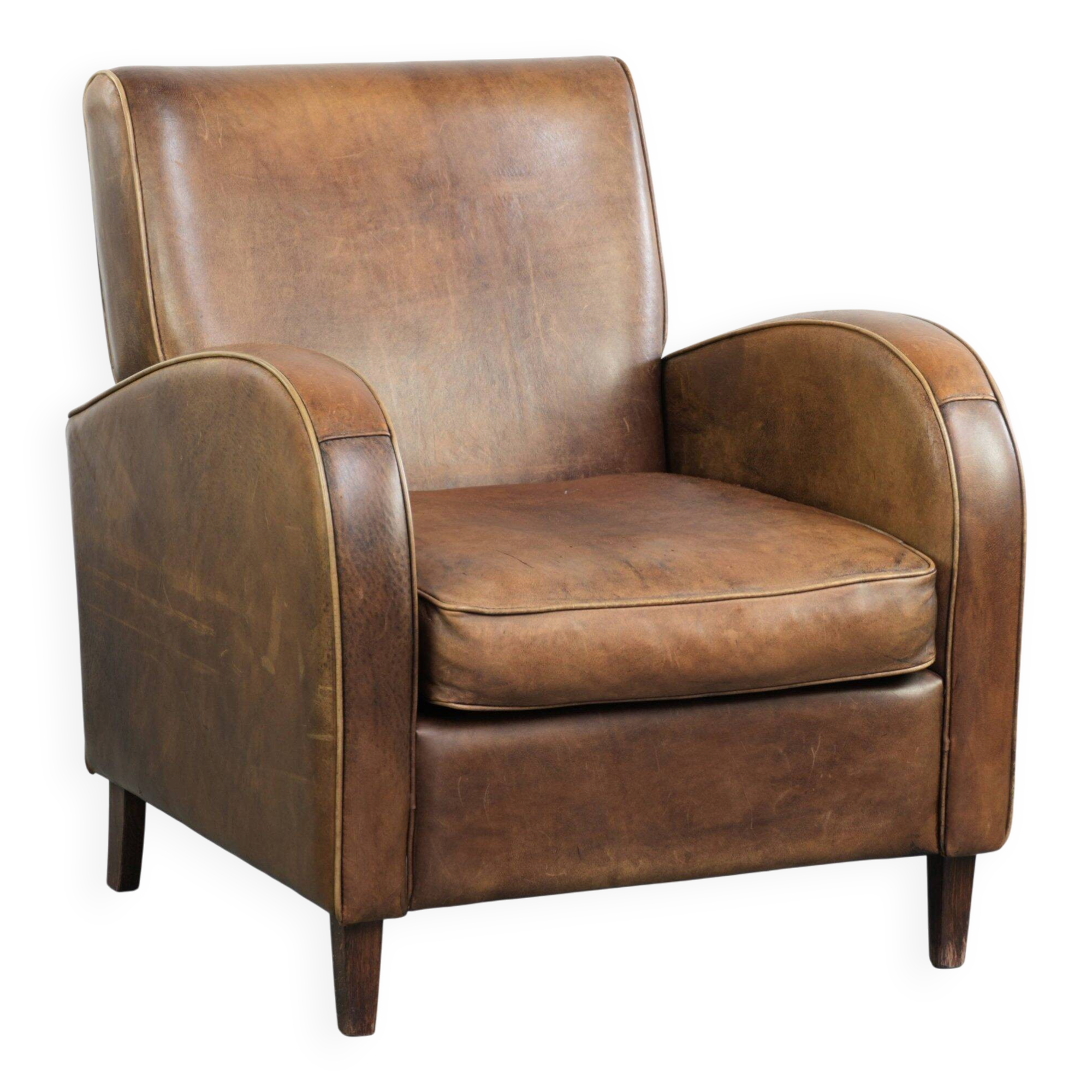 Sheepskin armchair in a light cognac colour with matching piping