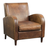 Sheepskin armchair in a light cognac colour with matching piping