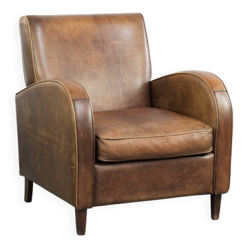 Sheepskin armchair in a light cognac colour with matching piping