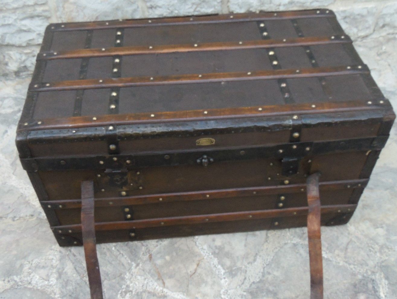 Old wooden and leather trunk, old brass nail trunk and leather strap