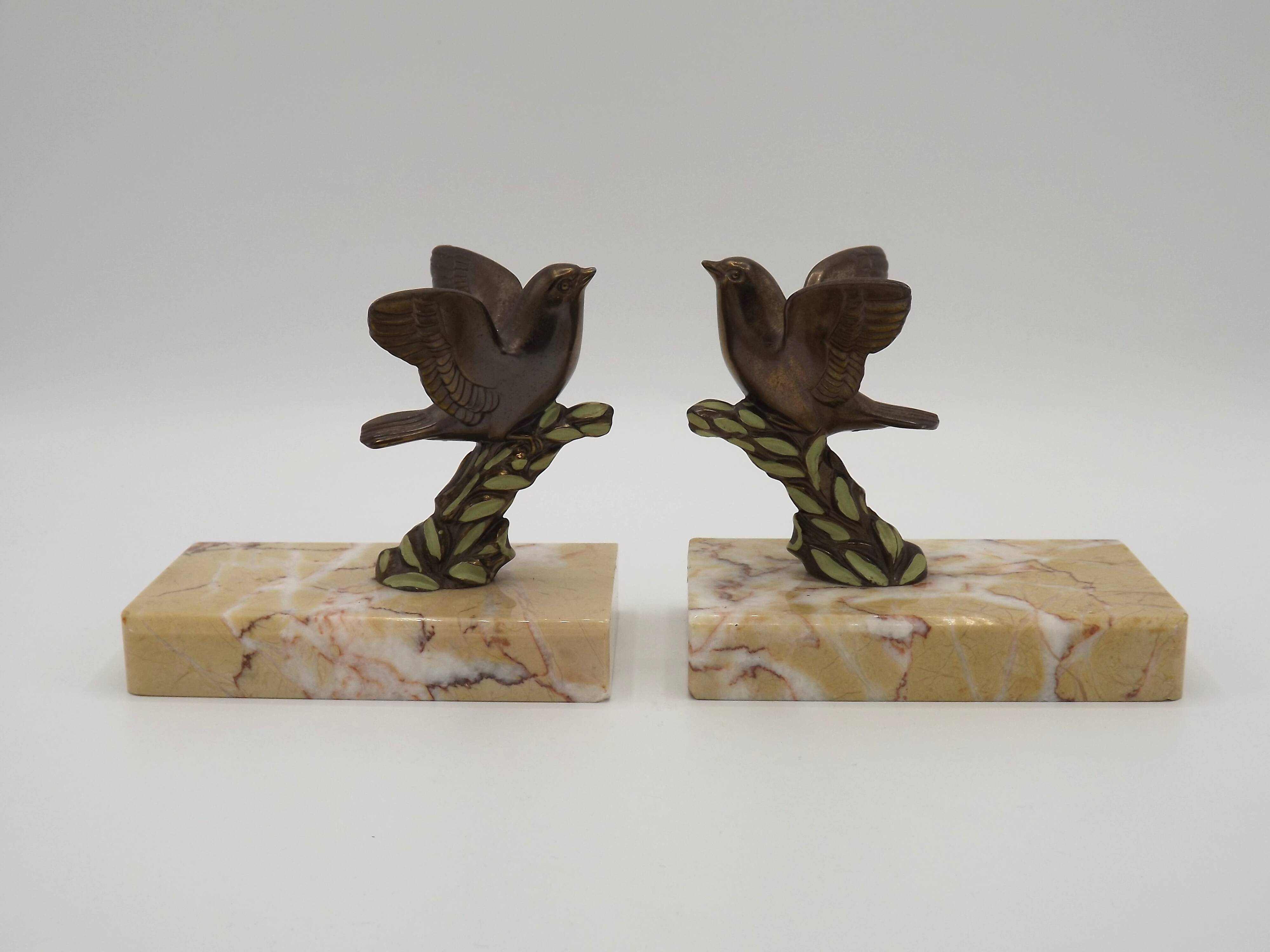 Paire de serre-livres Art déco français en étain représentant des oiseaux perchés sur une branche, socle en marbre