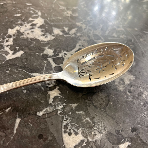 Openwork serving spoon, silver metal