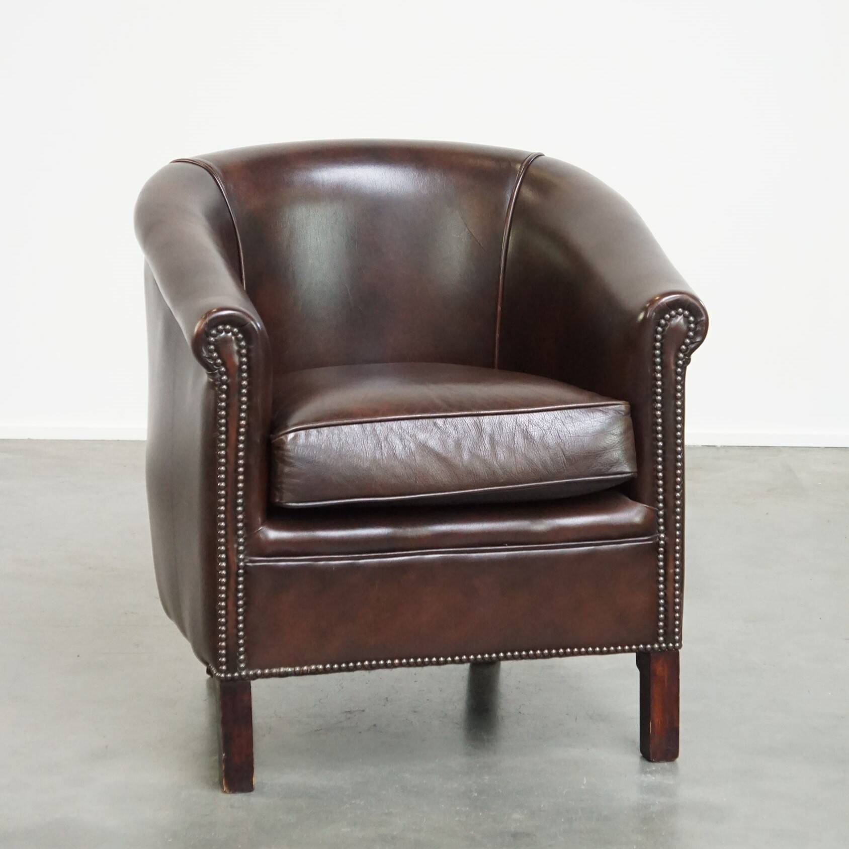 dark cowhide club chair in English style