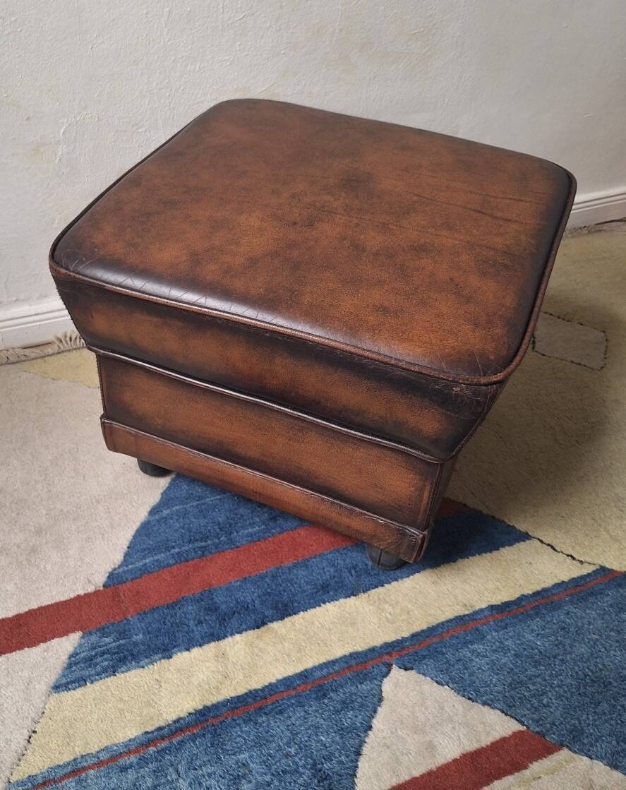 Vintage ottoman / pouffe in chestnut brown leather