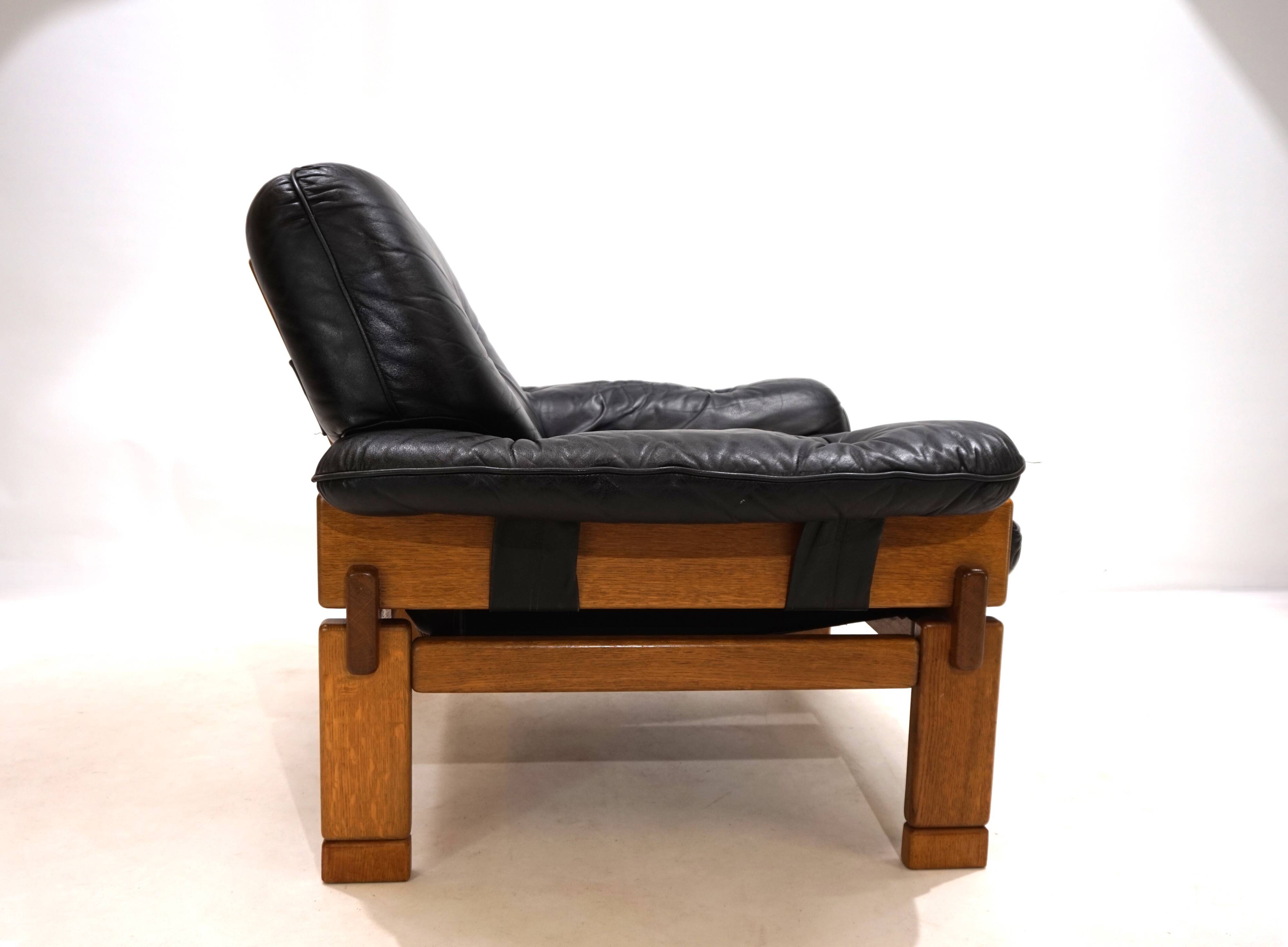 Fauteuil brutaliste cuir et chêne, 1960