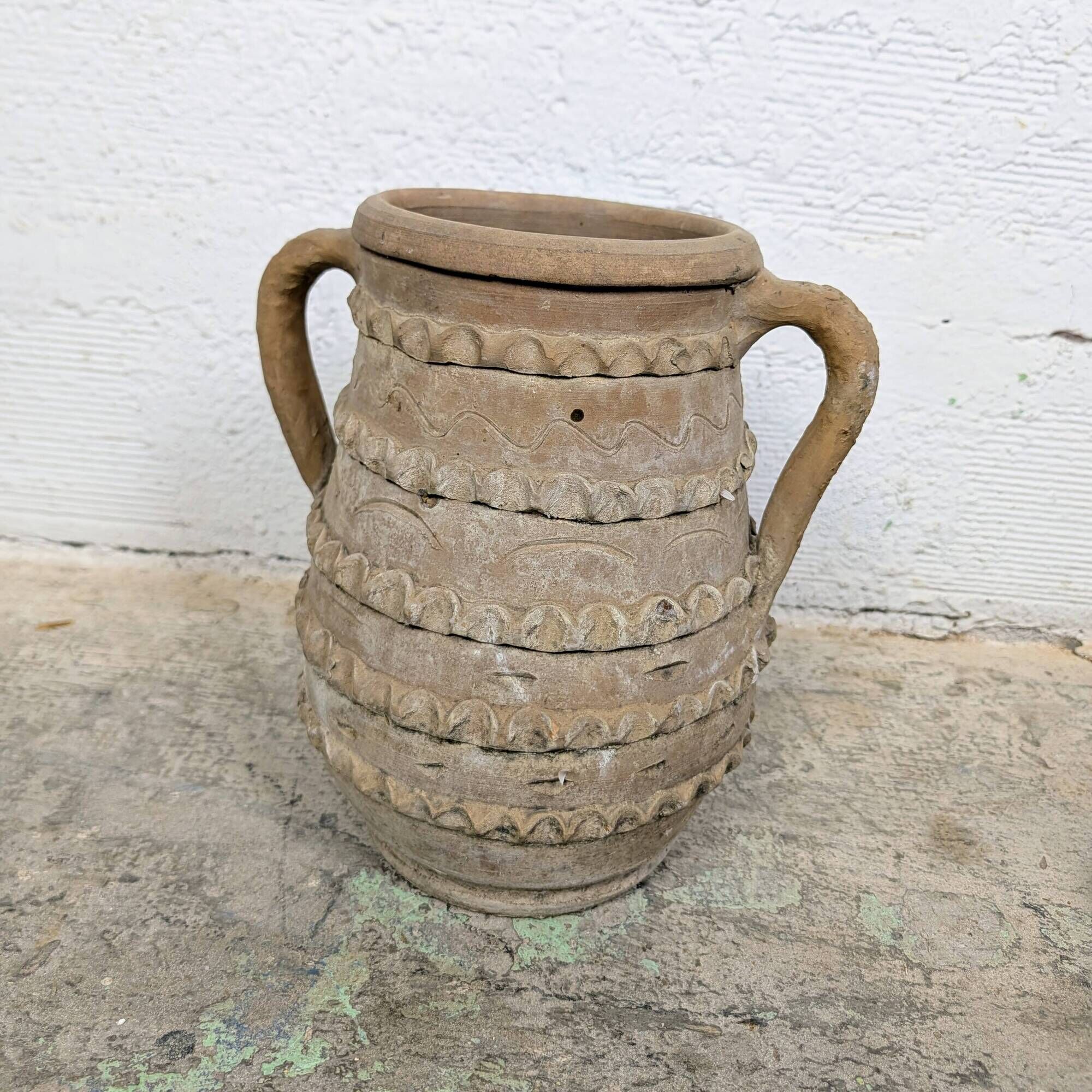 Terracotta jar with two handles, decorated with garlands.
