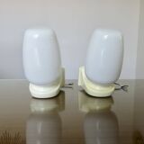 Pair of "streamline" opaline wall lights, France, 1970s-1980s.