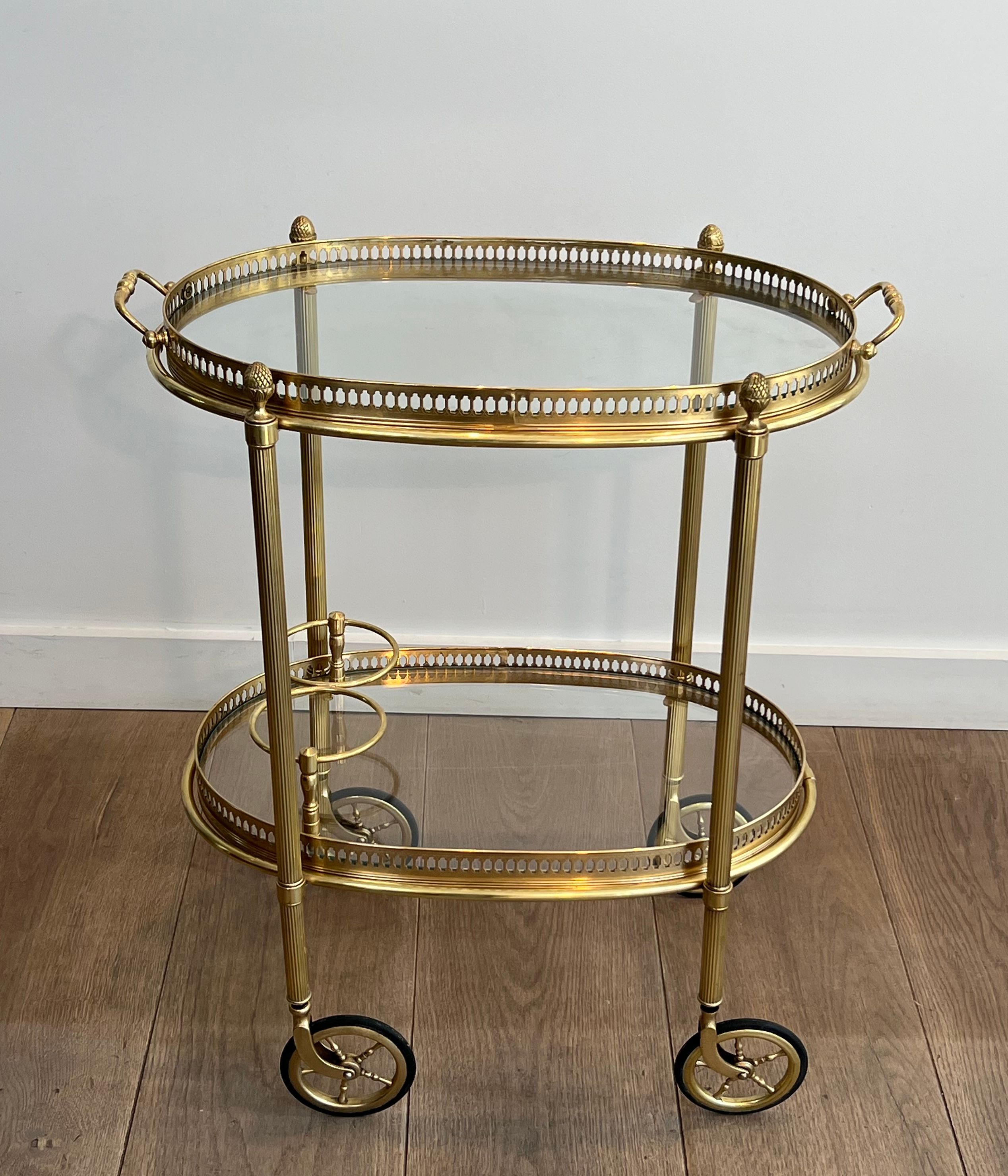 Small oval rolling table in brass with double removable trays from Maison Bagués.