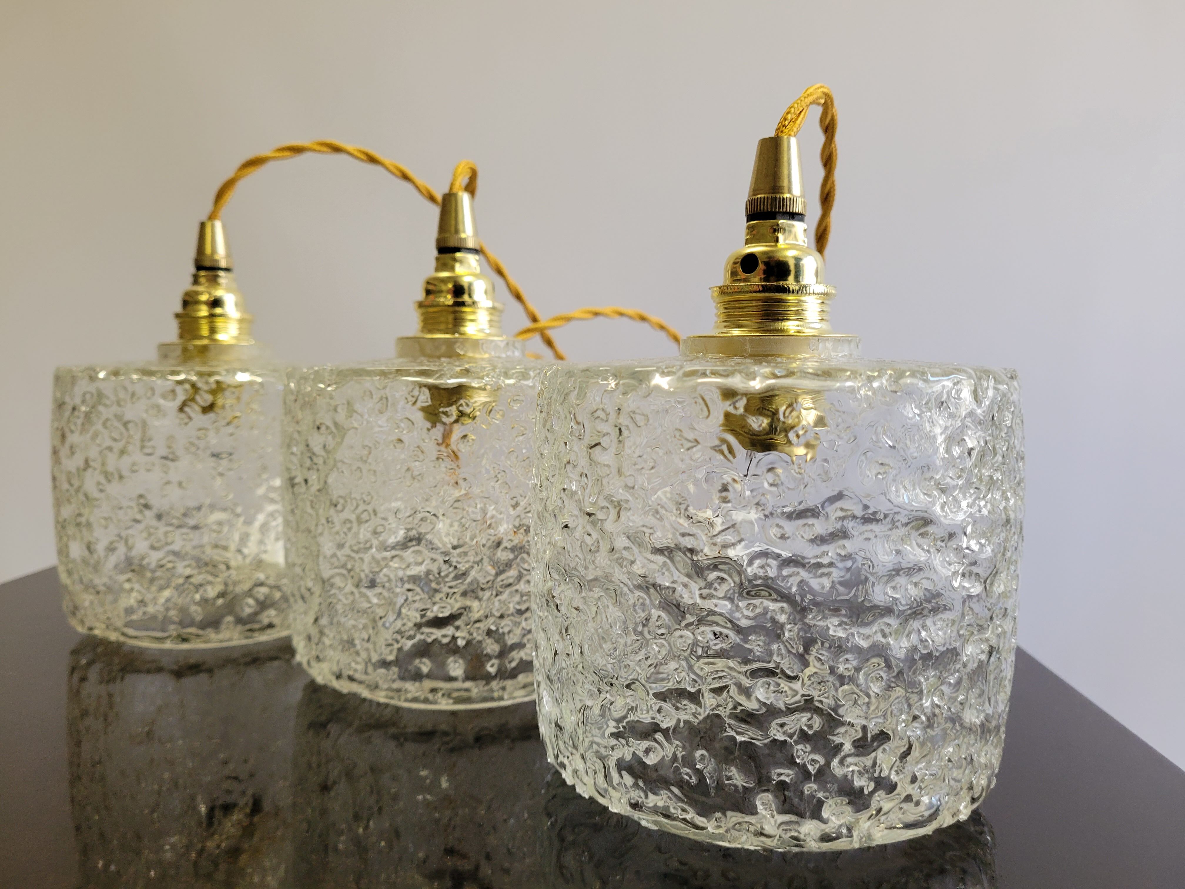 Trio of scrambled glass pendant lamps