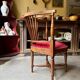 Corner armchair, dark wood and red velvet office chair.