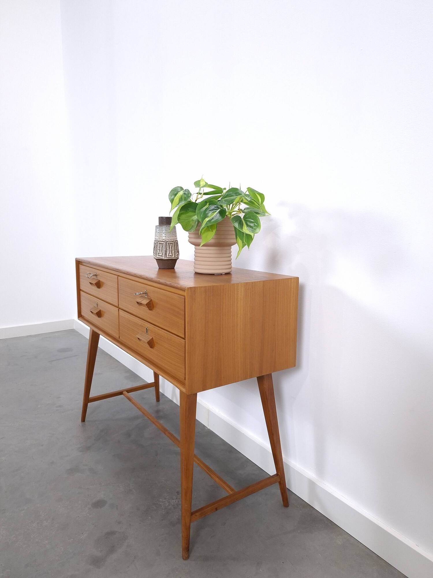 Vintage teak Danish chest of drawers with high slanted legs, side table, sideboard.