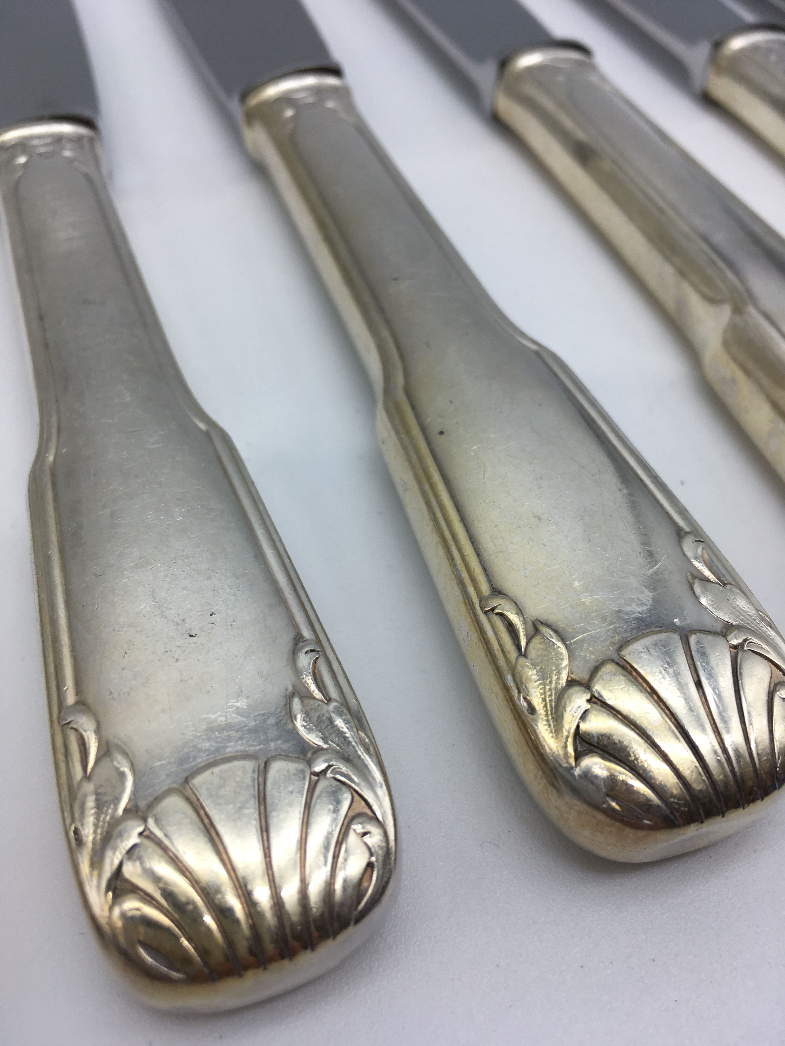 12 silver metal knives.