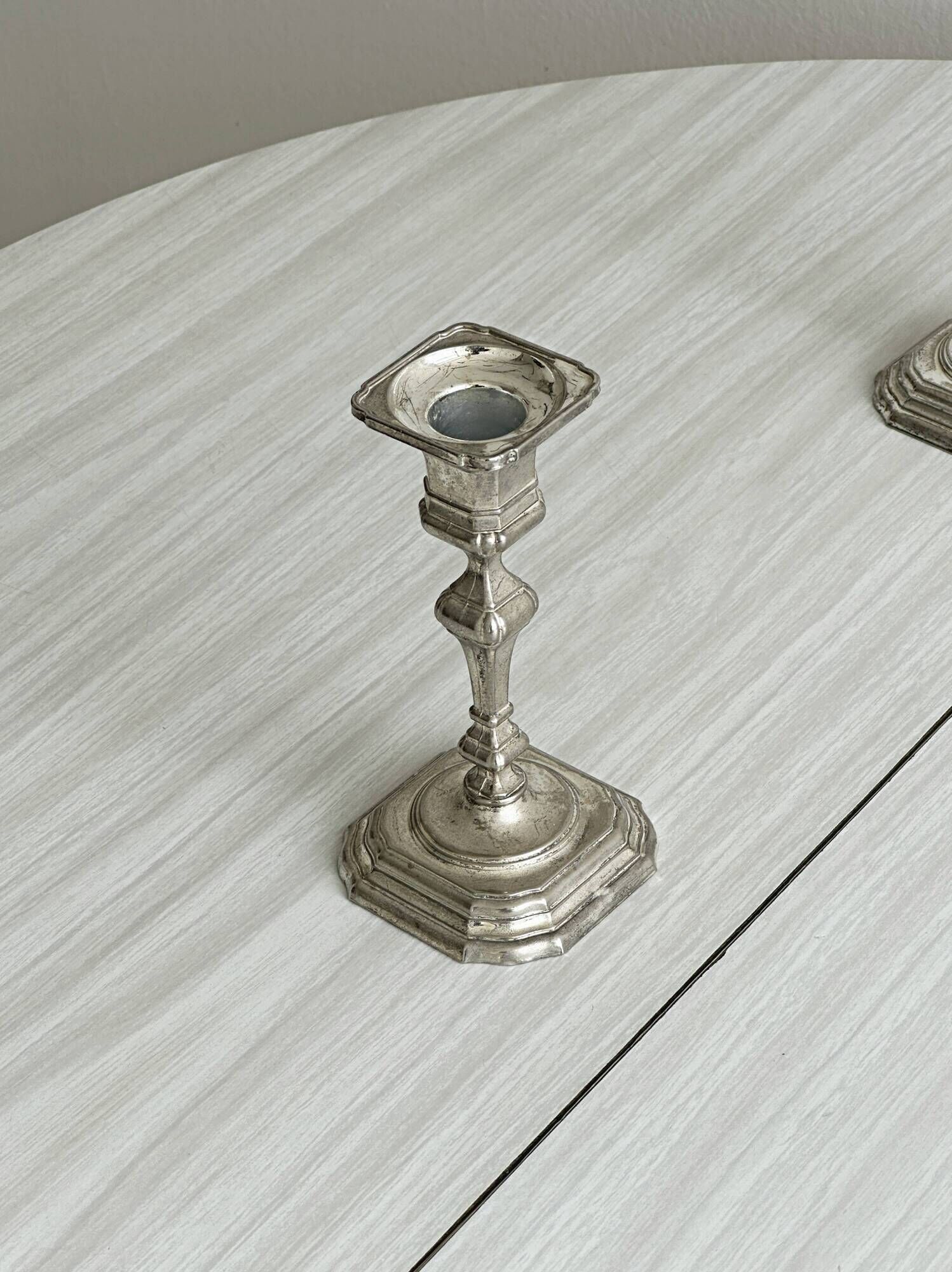 Pair of patinated silver-plated candlesticks