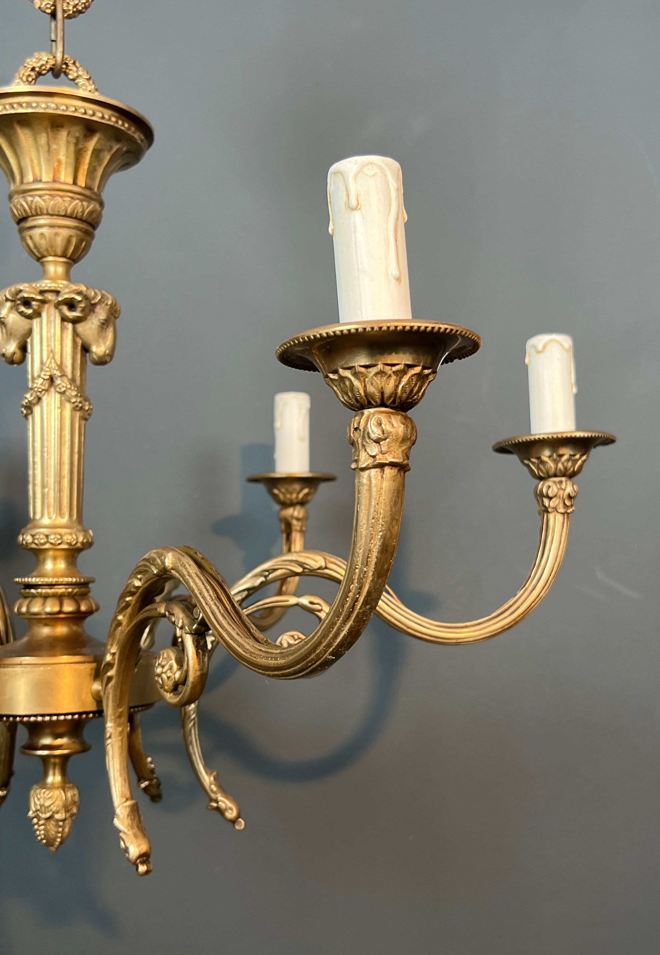 Bronze chandelier with ram's head motifs in the Louis XVI style, in the manner of Maison Jansen.