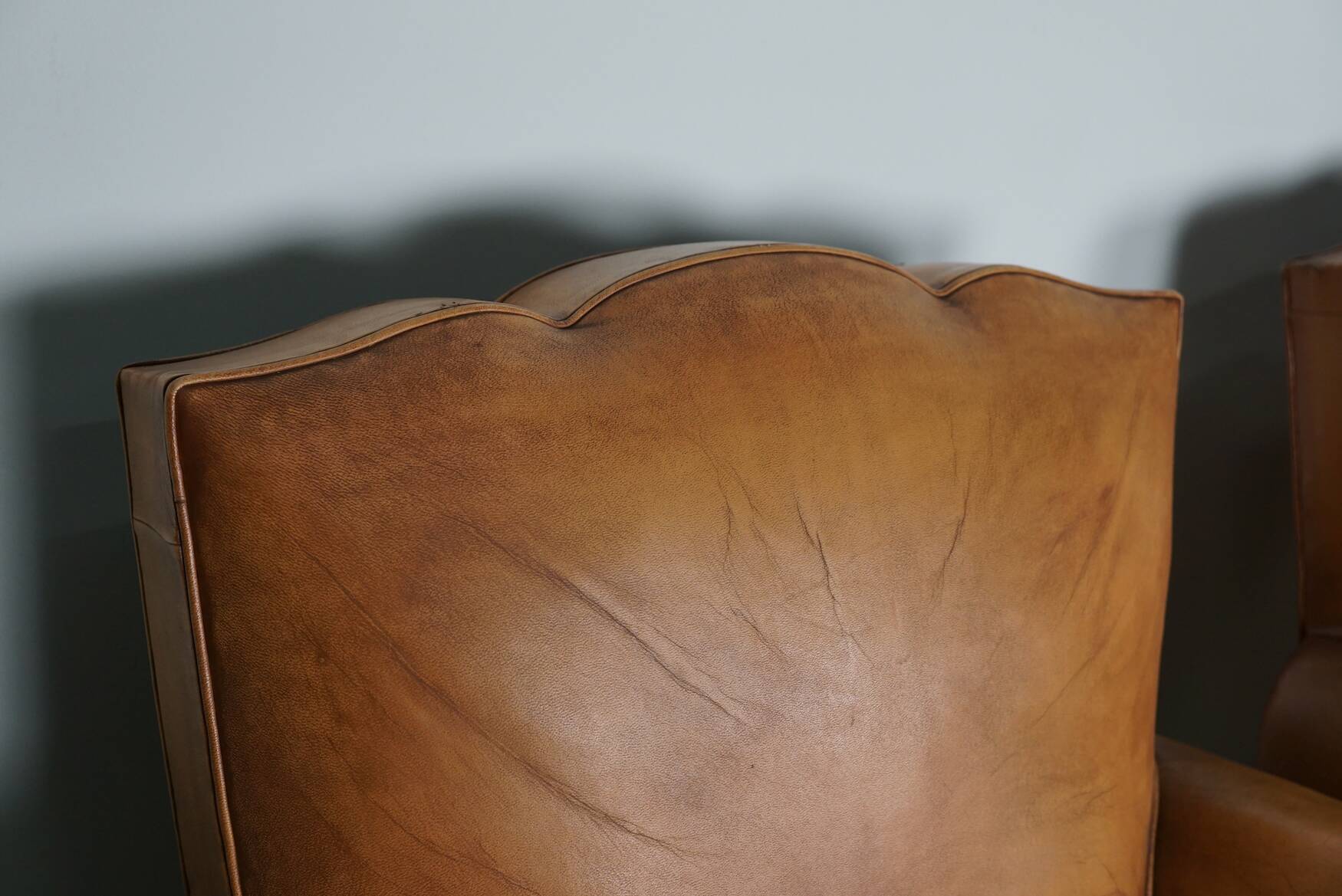 Pair of French Cognac Moustache Back Leather Club Chairs, 1950s