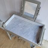 Antique wooden dressing table with marble top and mirror.