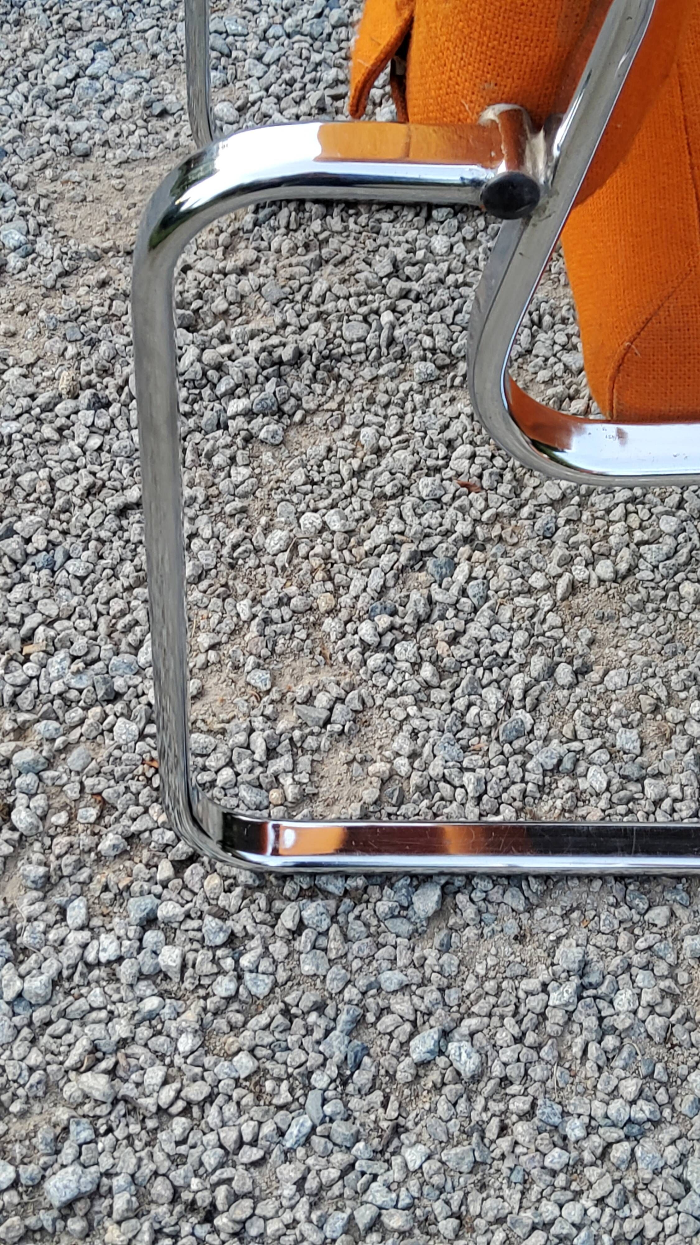 Pair of designer armchairs in orange fabrics and chrome tubes from the 70s