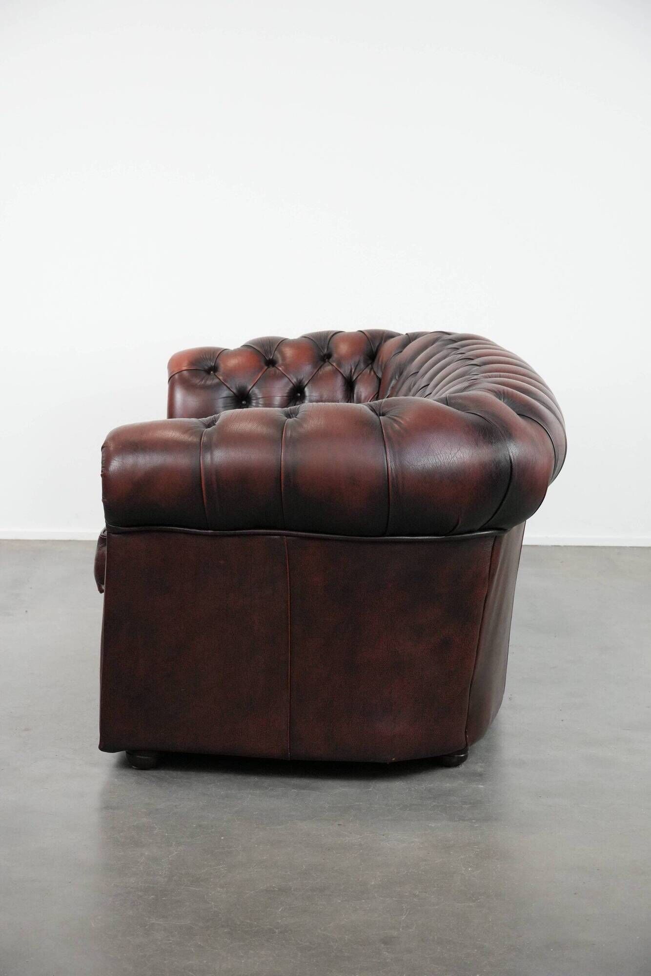Classic cowhide Chesterfield sofa in English style with red/brown colours