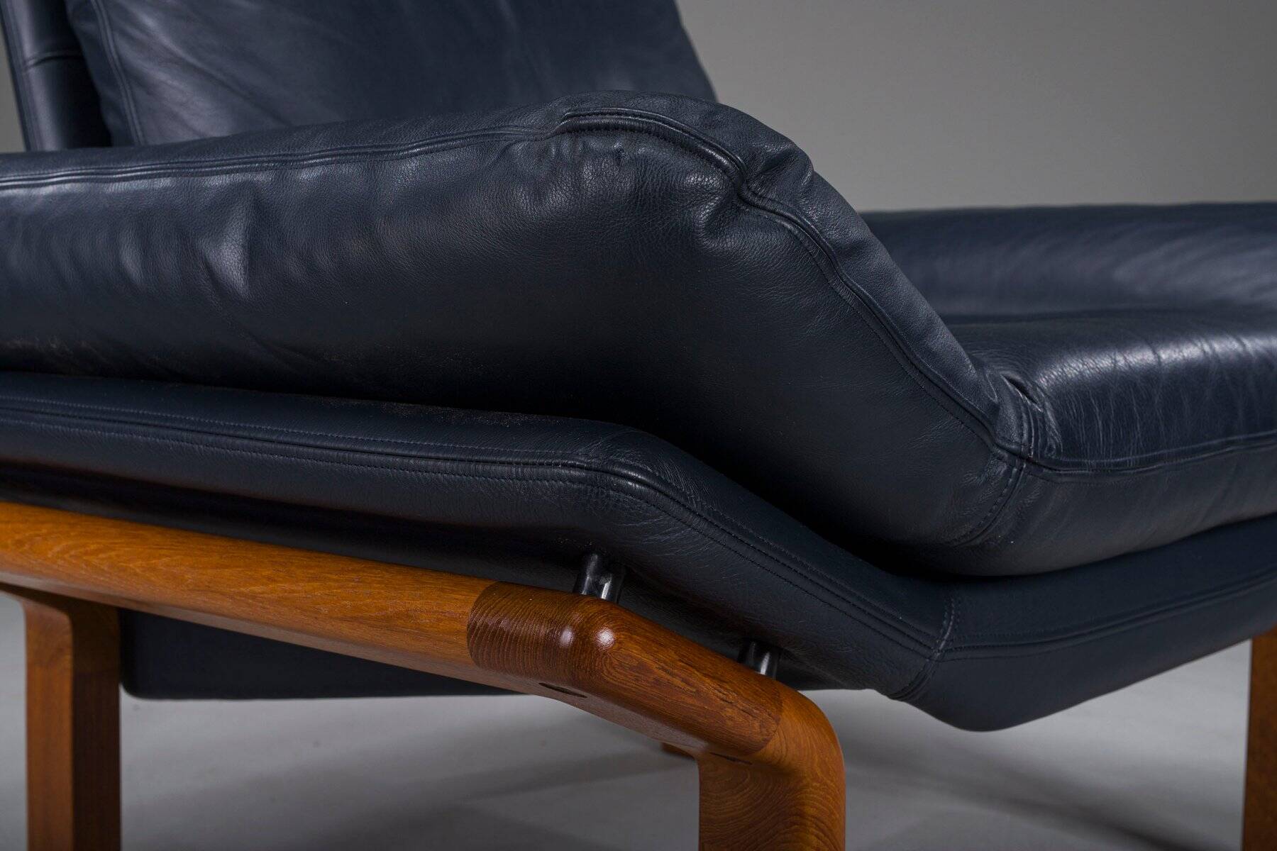 Danish teak and navy blue leather lounge chair from Komfort, 1970s