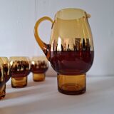 Carafe and its amber/gold glasses from the 70s