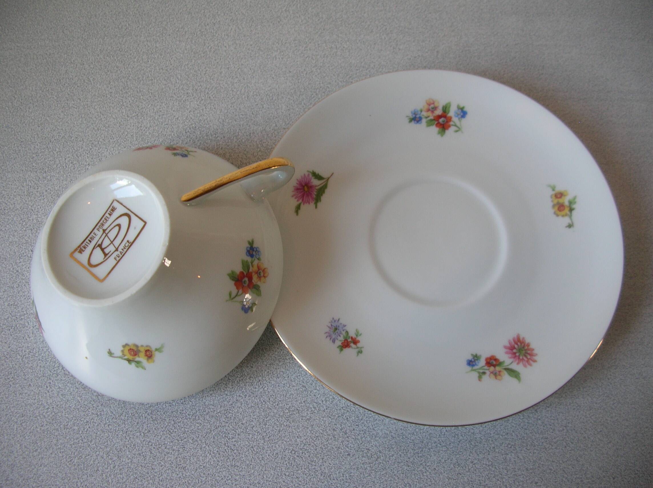Old large tea cup and saucer in Limoges porcelain with flower decor