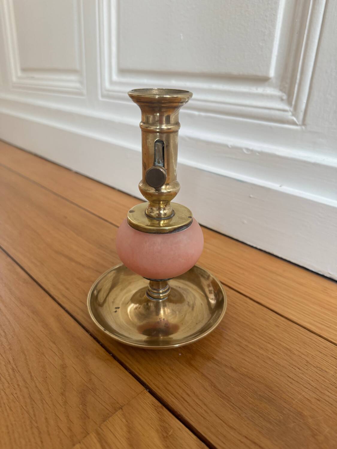 Pink glass and brass candlestick