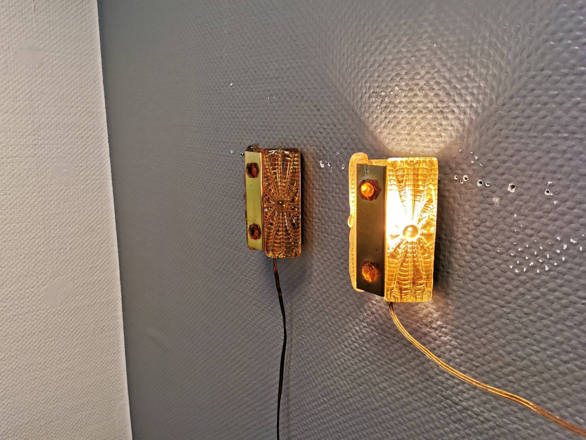 A pair of wall lights with brass-colored suspension with thick pressed glass. Vitrika, Denmark