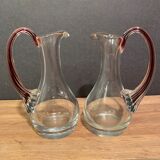 pair of crystal buires, handles with red tinted net decoration in the mass