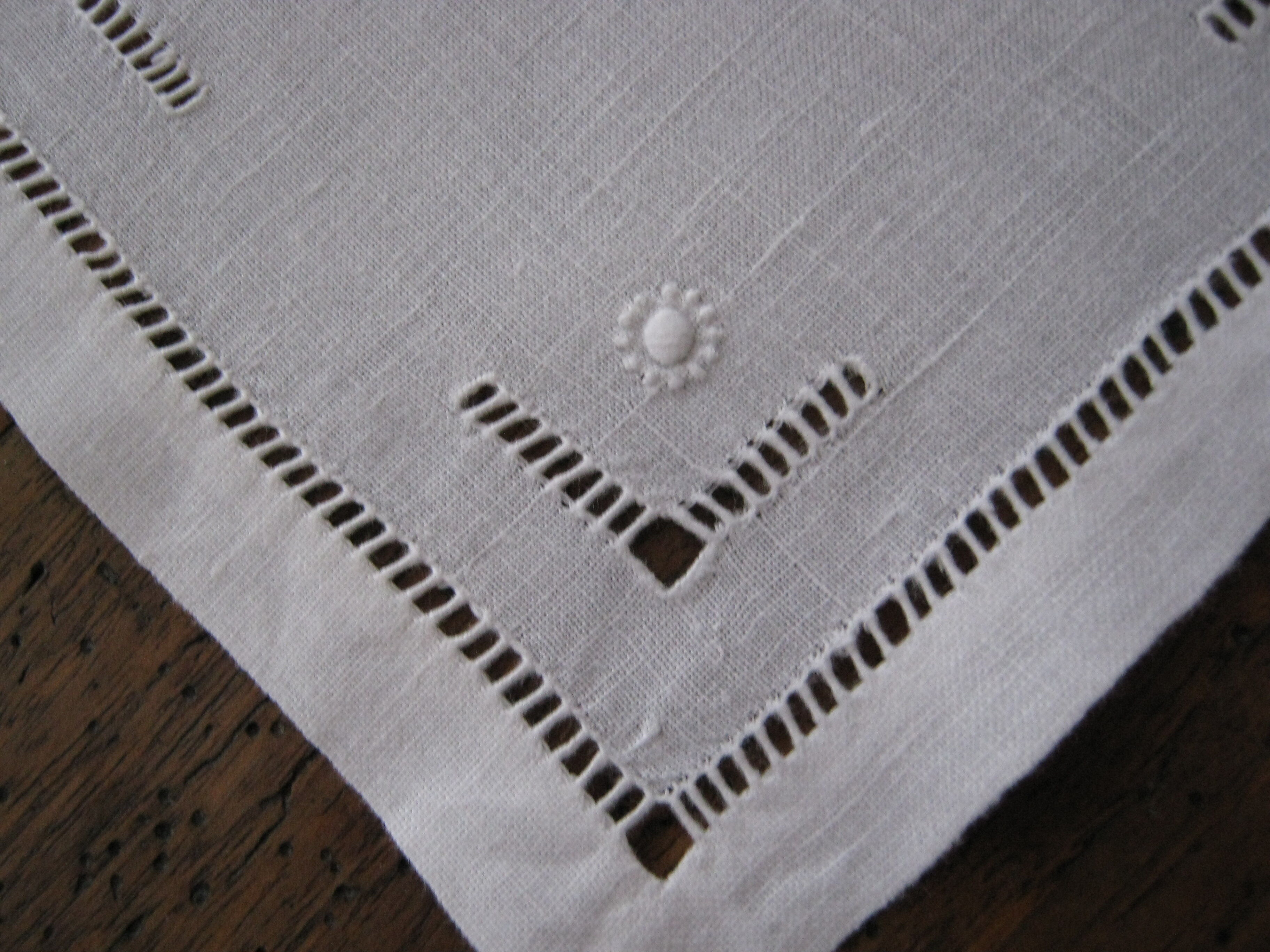 Under glass / small hand embroidered white cotton doilies