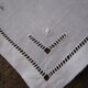 Under glass / small hand embroidered white cotton doilies
