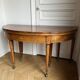Large oval table from the early 19th century in walnut, 3.17m with extensions.