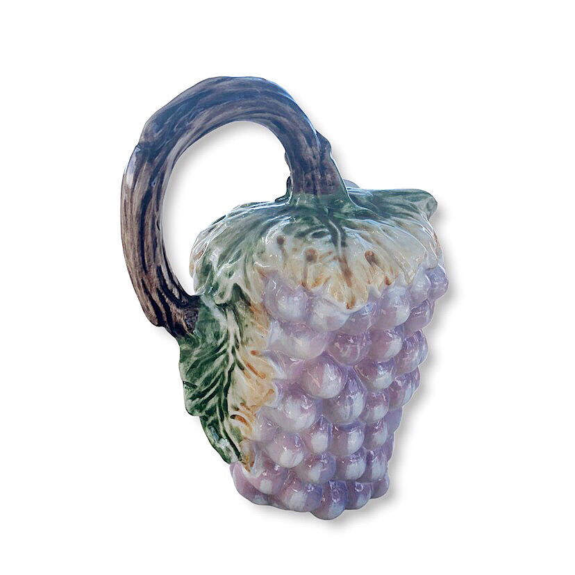 Old bunch pitcher of dabbling grapes