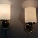 Pair of wall lights in gilded brass, black metal and opaline, 1960