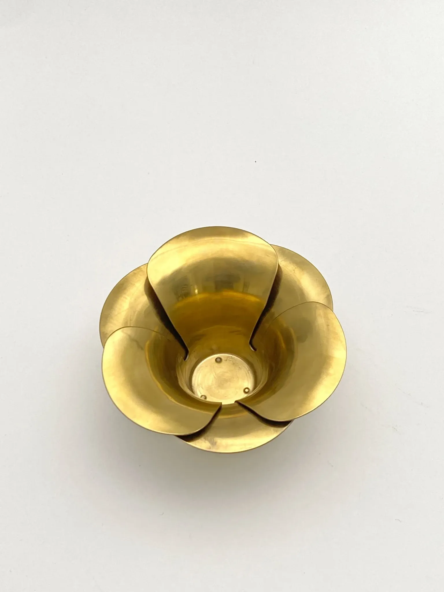 Brass candle holders in the shape of a flower.