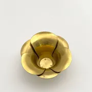 Brass candle holders in the shape of a flower.