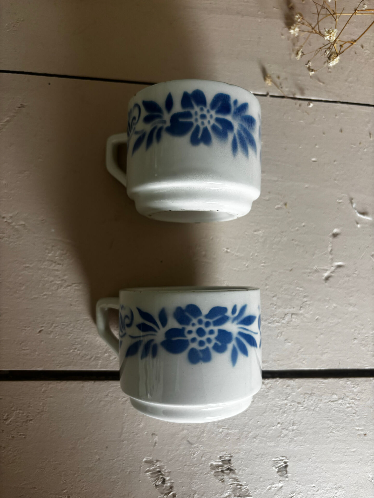 Set of 3 antique ceramic cups with blue floral pattern.