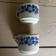 Set of 3 antique ceramic cups with blue floral pattern.