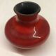 Red ceramic ball vase signed A
