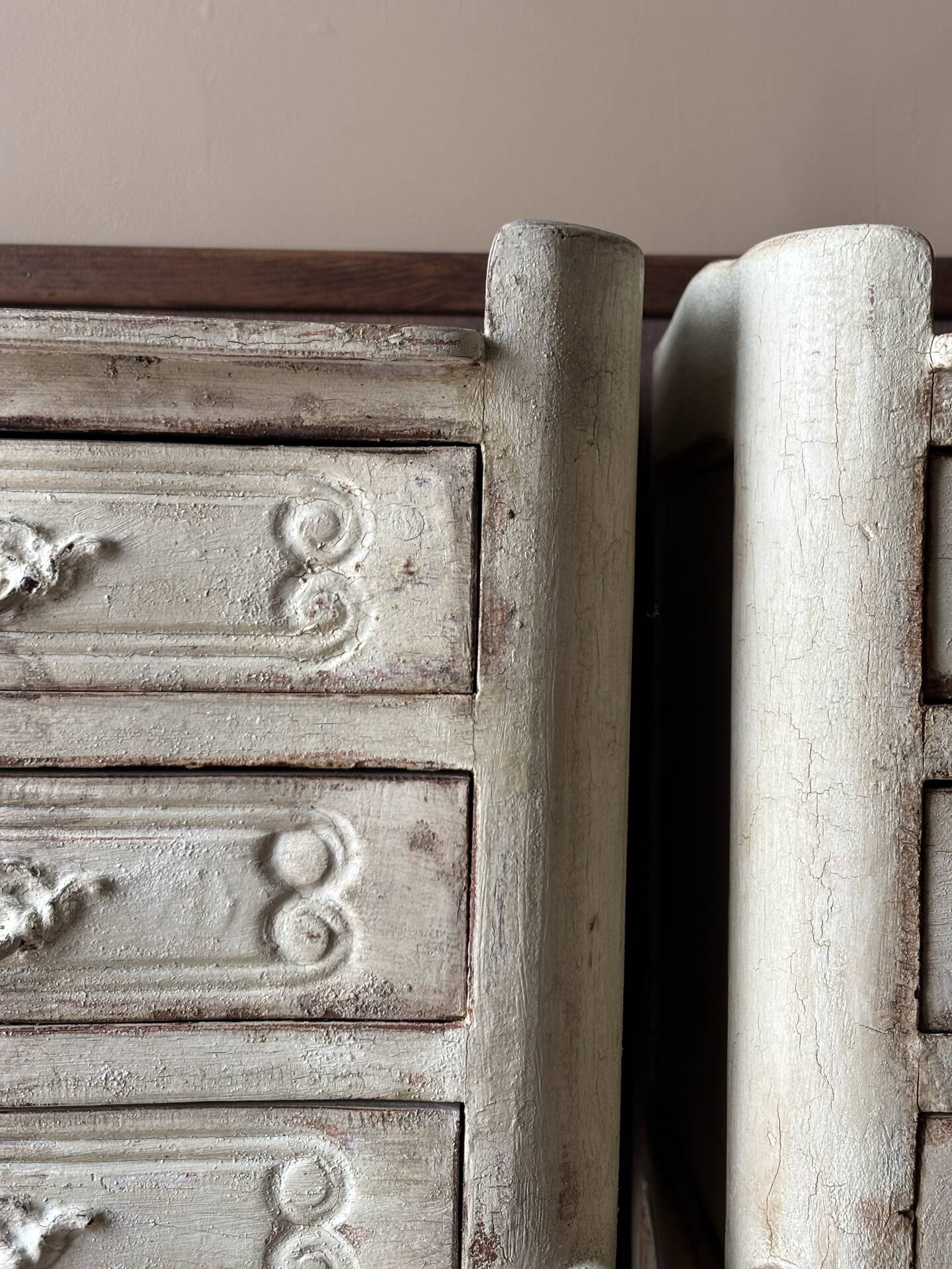 A pair of distressed bedside tables.