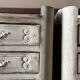 A pair of distressed bedside tables.