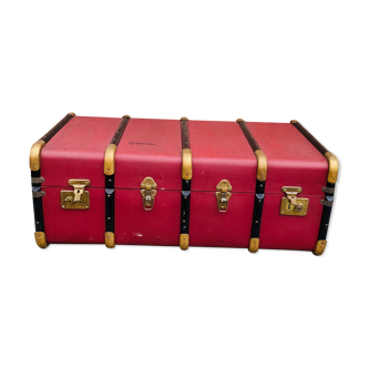 Old travel chest in burgundy leather