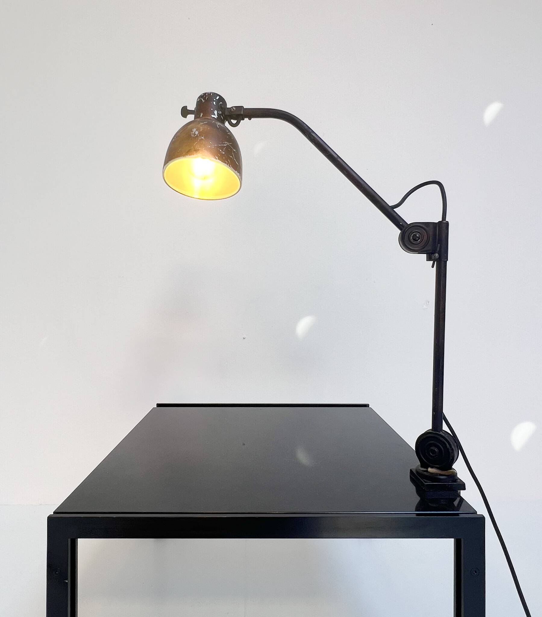 Industrial in height to be adjusted vintage clamp lamp from the 1970s