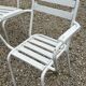 Garden furniture in wrought iron and wooden slats composed of two armchairs, 4 chairs and a table.