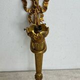 Bronze wall light, decorated with a bow and ribbon.