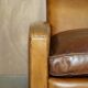 Three-seater Art Deco style leather sofa with feather cushions.