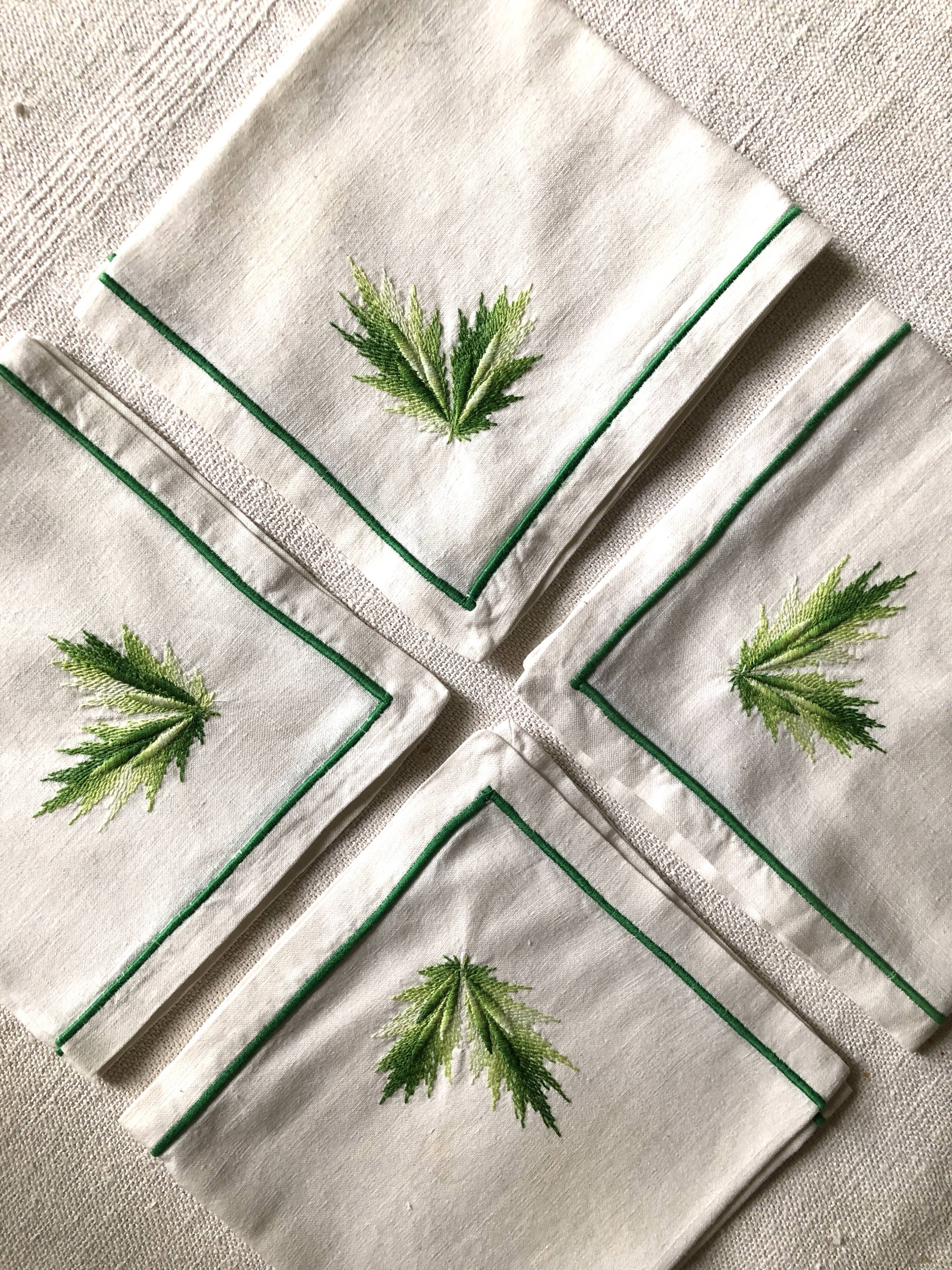 Series of four embroidered linen napkins