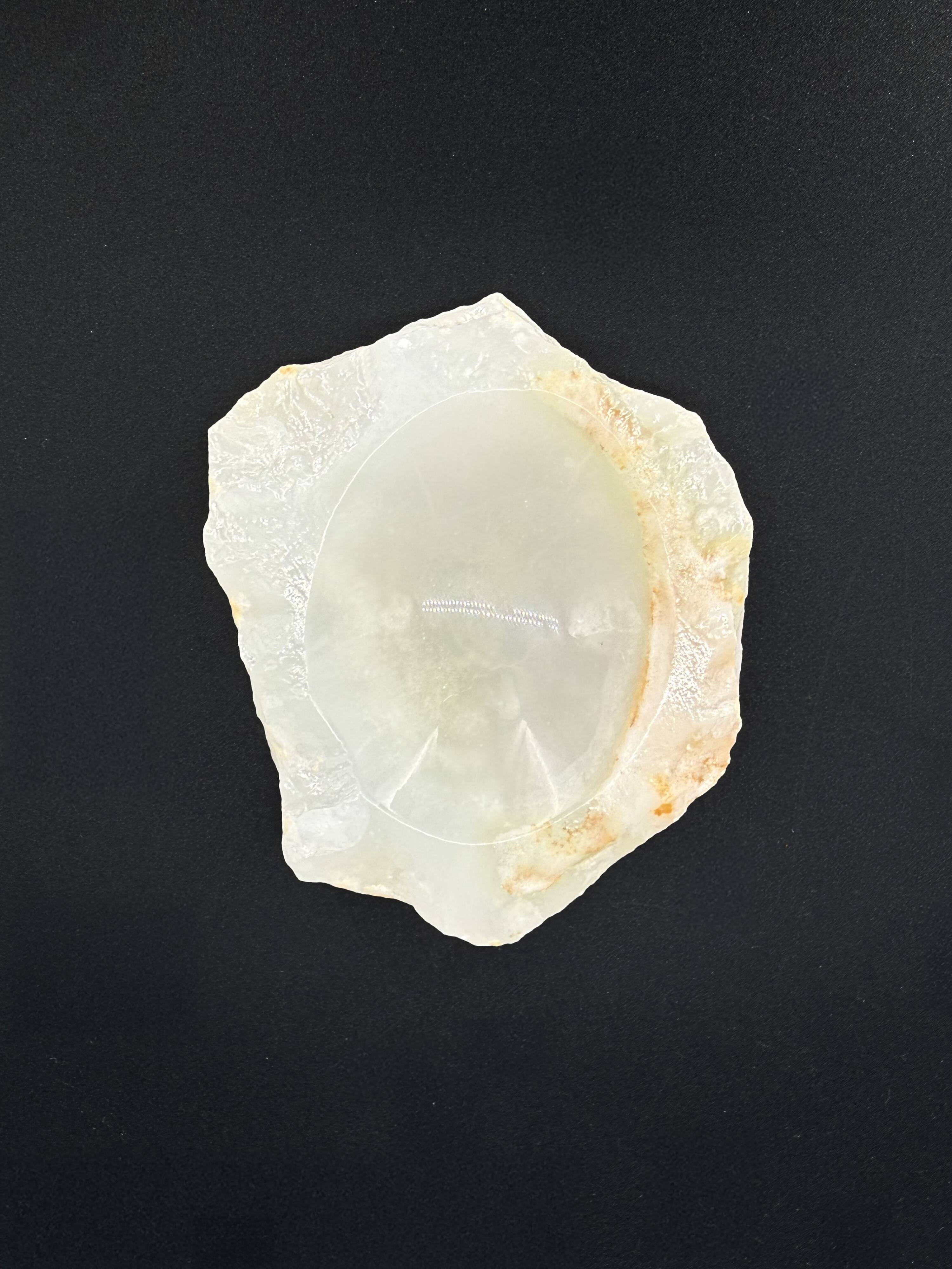 Empty pocket bowl made of translucent natural stone.